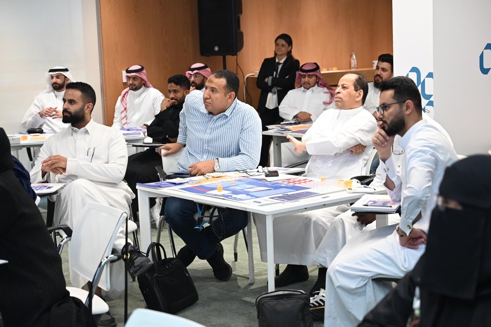 Founder and finance manager reviewing a 2027 SME business growth strategy on a whiteboard in a Dubai office